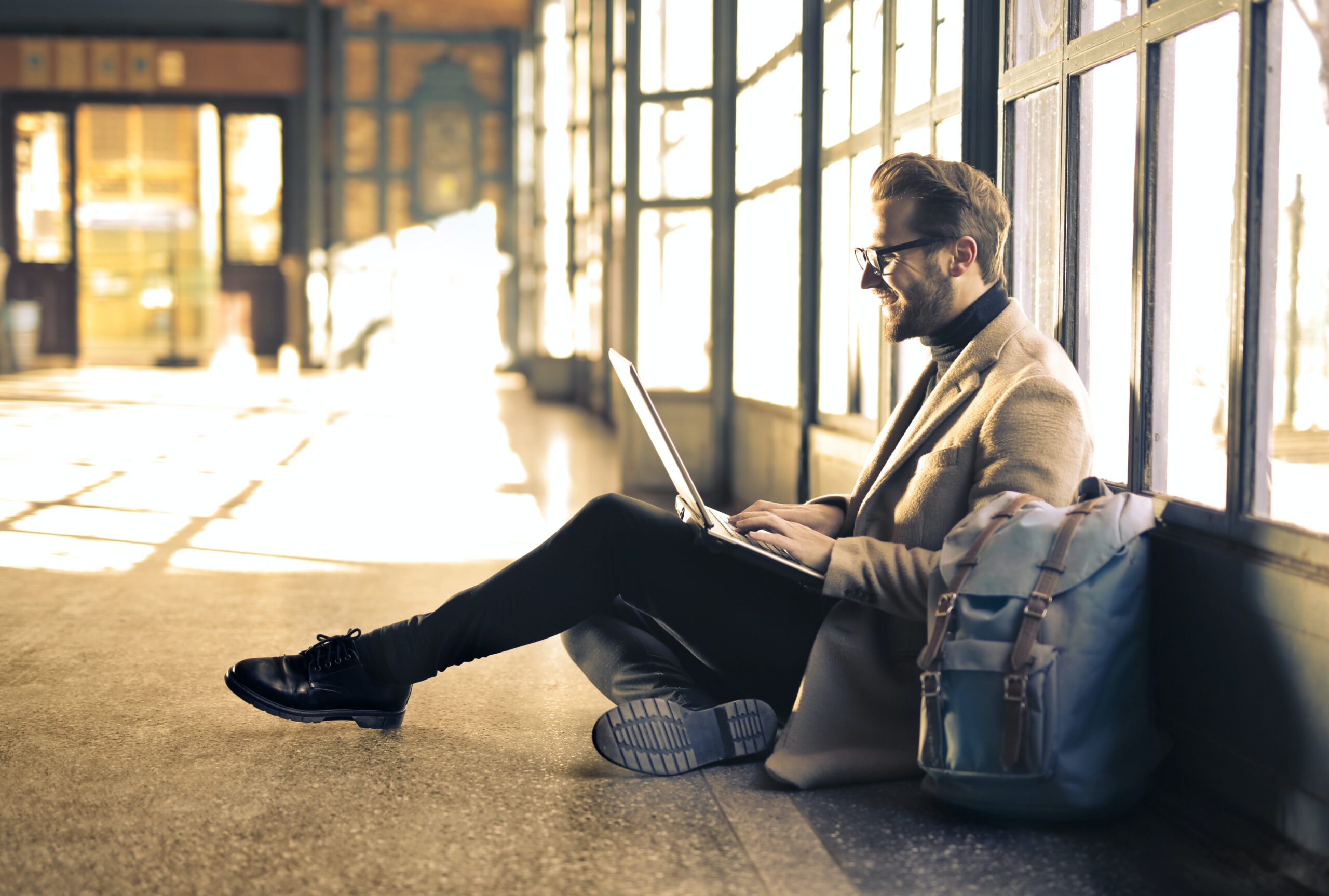 man-sitting-down-and-working-on-laptop