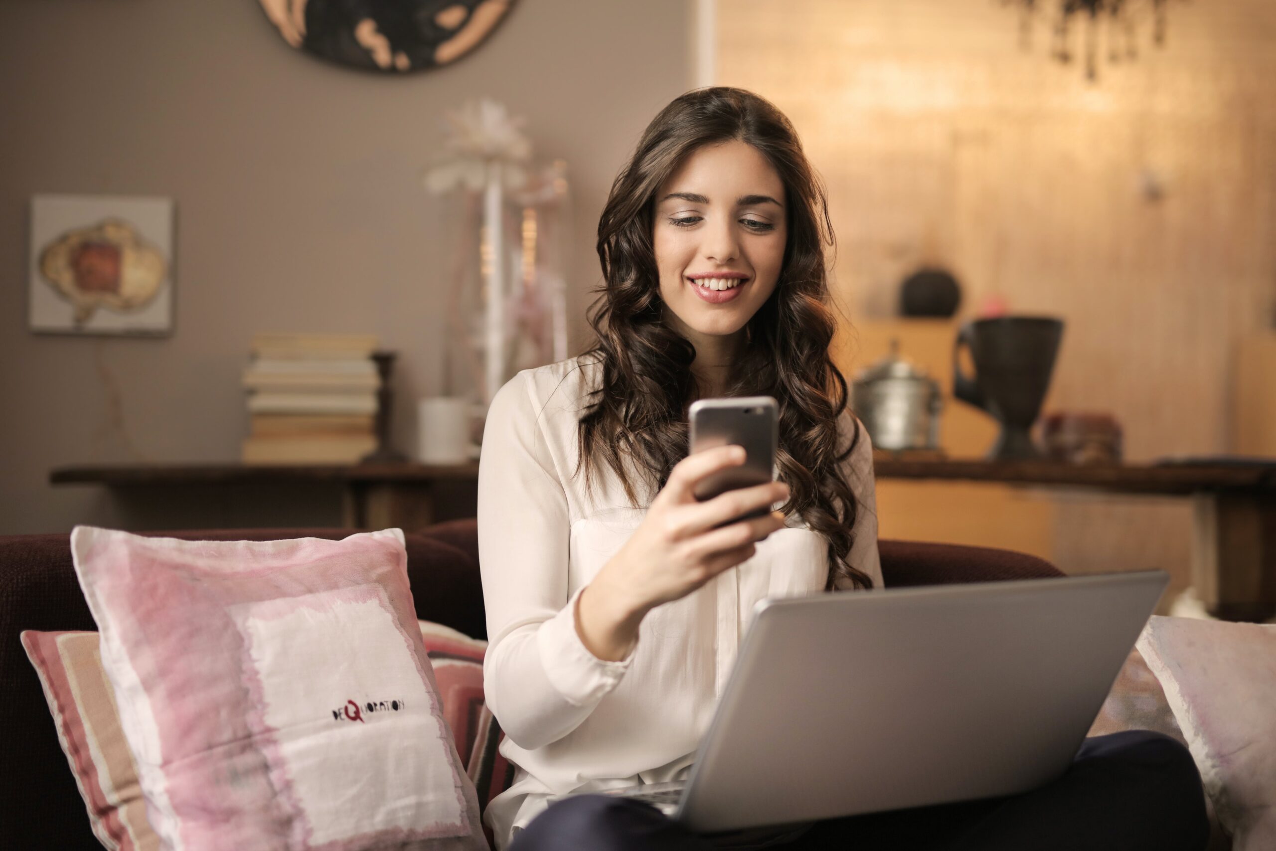 woman-texting-in-front-of-laptop